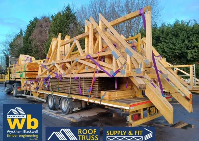A Wyckham Blackwell branded, articulated flatbed lorry transporting two full loads of roof trusses to a client in Bedford.